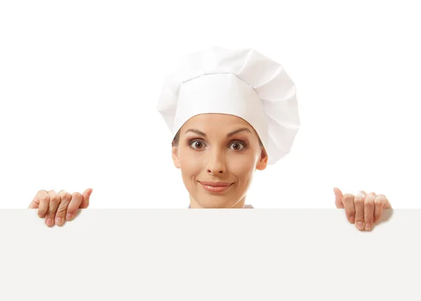 Woman cook looking over paper sign billboard. — Stock Photo, Image