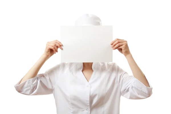 Woman nurse showing blank sign board, isolated. Stock Image