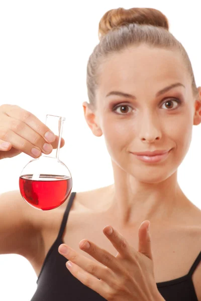 Woman in sports suit holds flask with red liquid — Stock Photo, Image