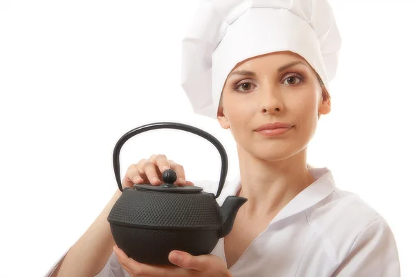 Female cook / chef in uniform with teapot — Stock Photo, Image