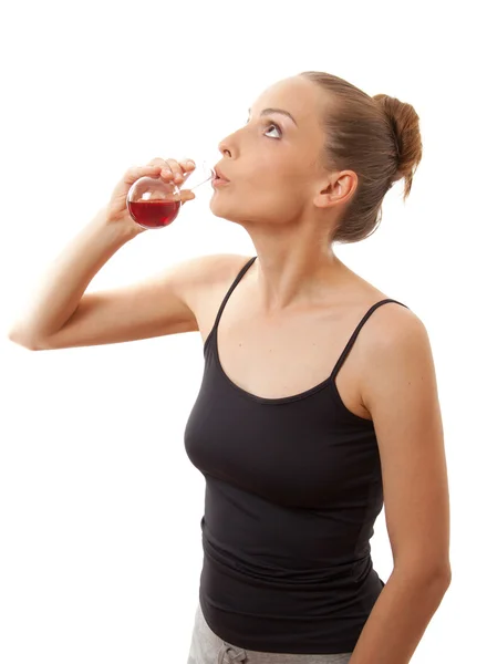 Woman drinking a red liquid — Stock Photo, Image