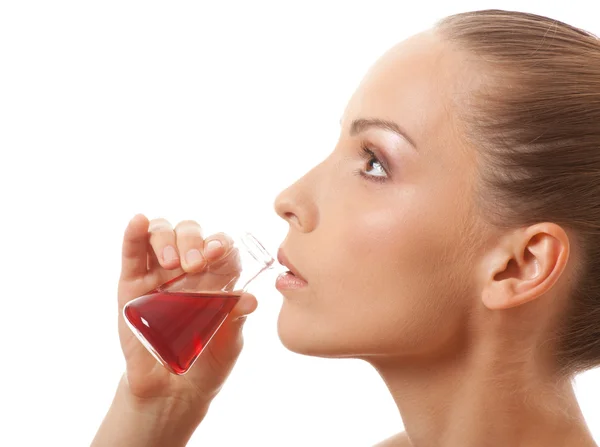 Woman drinking a red liquid Stock Picture