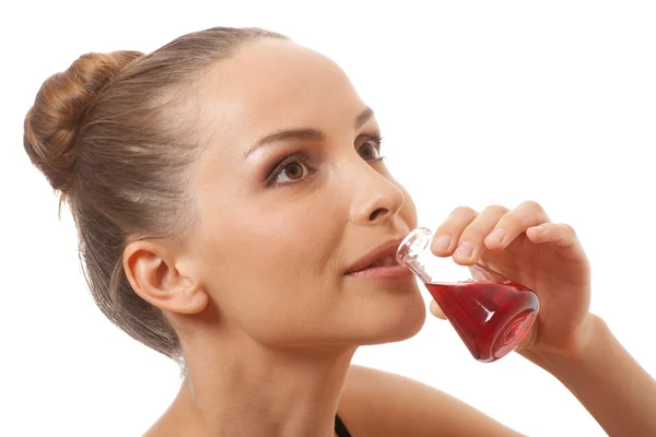 Woman drinking a red liquid — Stock Photo, Image