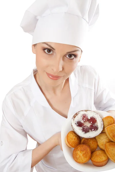 Woman chef holding tray of cookies. Stock Picture