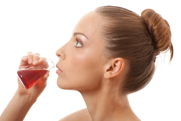 Woman drinking a red liquid Royalty Free Stock Images