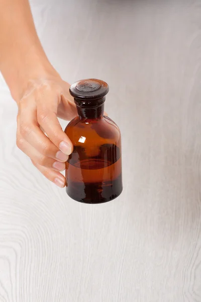 Mano con botella pequeña — Foto de Stock