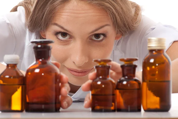 Woman doctor with medication in glass bottles — Stock Photo, Image