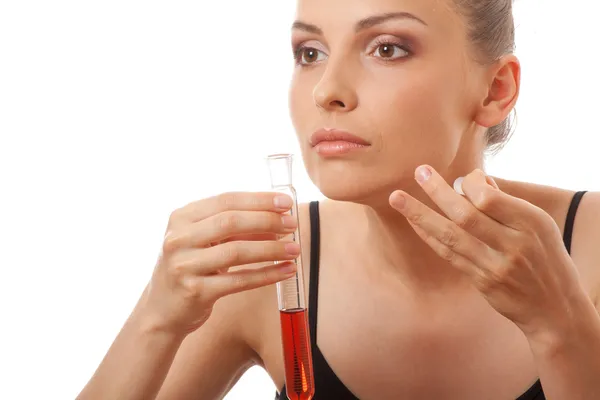 Woman holding test tube with red liquid — Stock Photo, Image