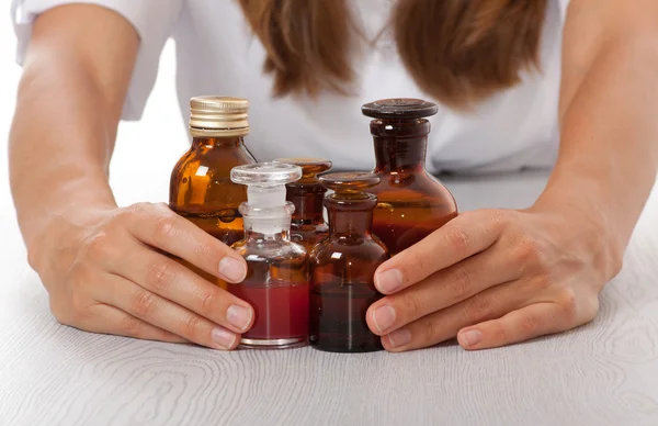 Doctor's hand with bottles of medicine — Stock Photo, Image