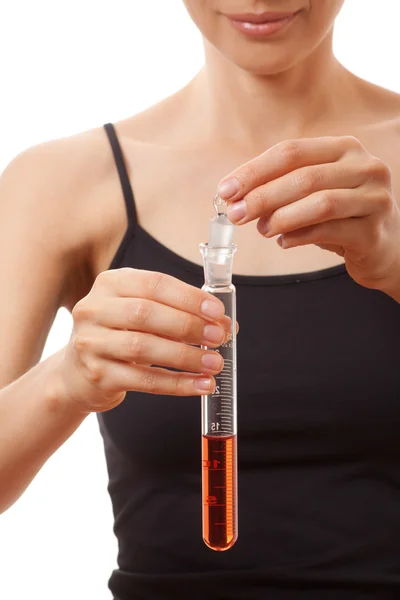 Woman holding test tube with red liquid — Stock Photo, Image