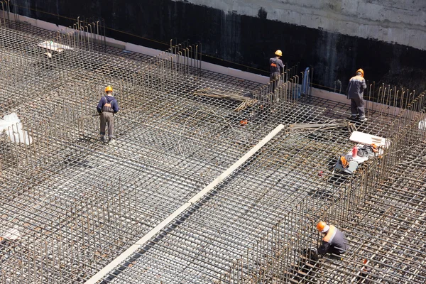 Trabajadores hacen refuerzo para cimentación de hormigón — Foto de Stock