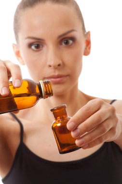 Young woman holding two bottles of medicine clipart