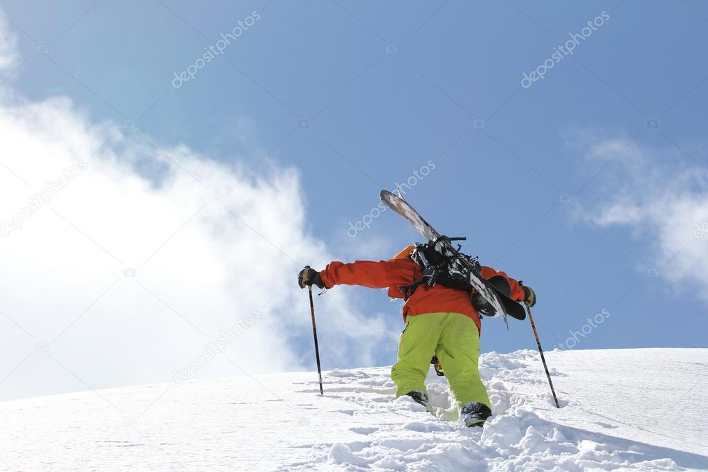 Skier climbing a snowy mountain