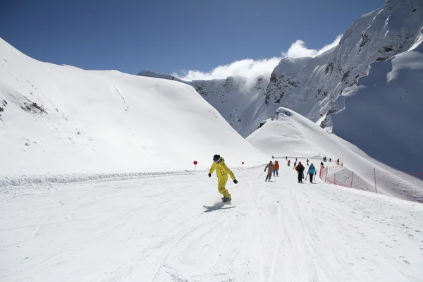 Skiers going down the slope at ski resort — Stock Photo, Image