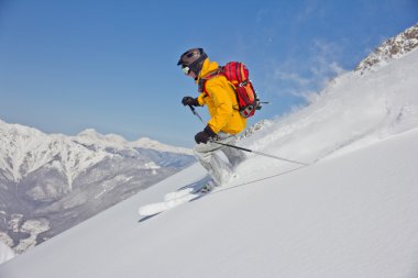 Skier in deep powder, extreme freeride clipart