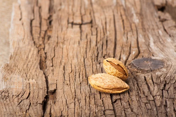Almonds on wooden board — Stock Photo, Image