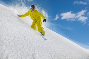 Snowboard rider moving down in snow powder clipart