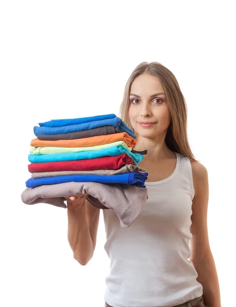 Young woman holding a pile of clothes — Stock Photo, Image