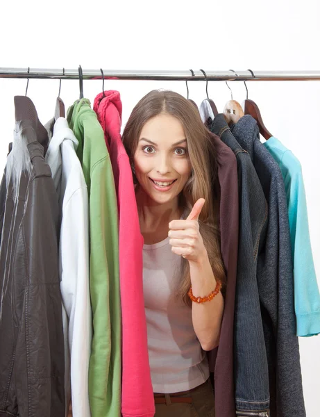 Young woman near rack with hangers — Stock Photo, Image
