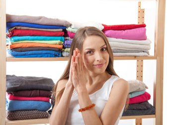 Young woman standing near the wardrobe clipart