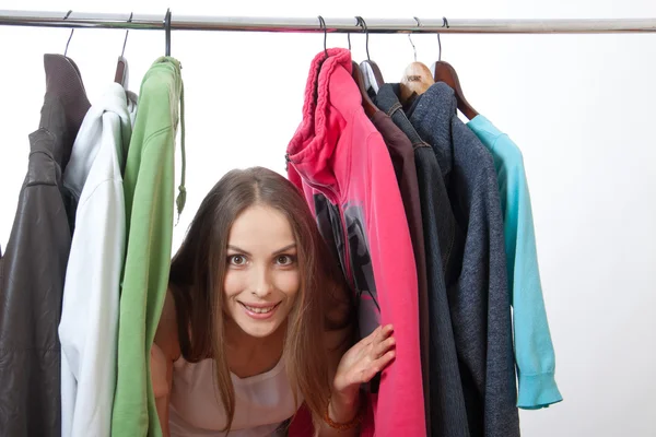 Young woman near rack with hangers Stock Photo