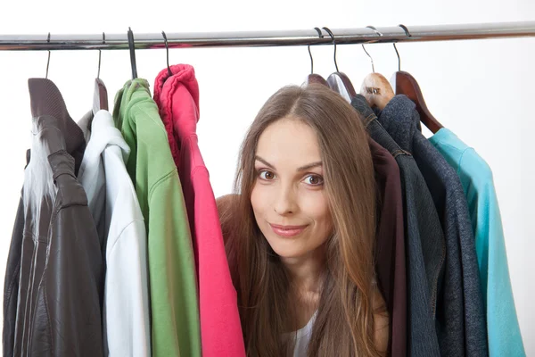 Young woman near rack with hangers Royalty Free Stock Photos