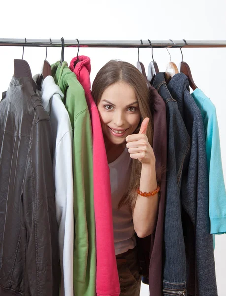 Young woman near rack with hangers Stock Photo