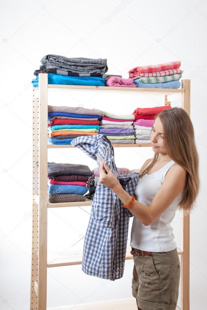 Young woman standing near the wardrobe