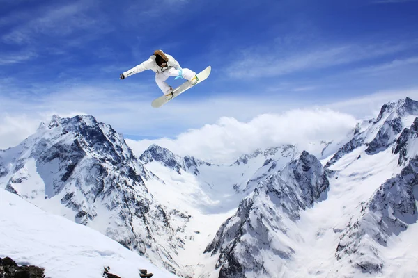 flying snowboarder on mountains