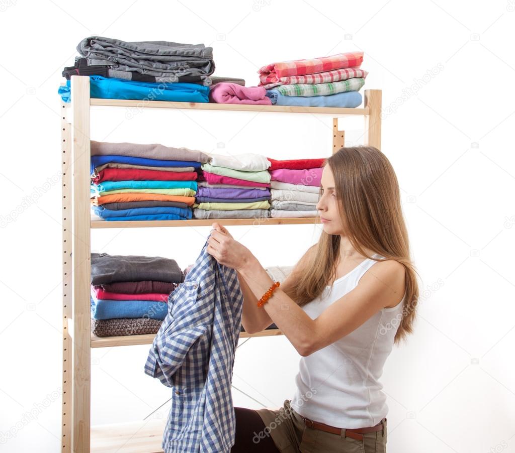 Young woman standing near the wardrobe