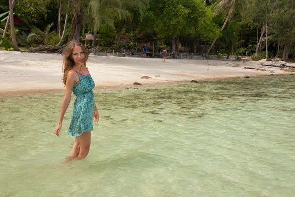 Woman standing knee-deep in water — Stock Photo, Image