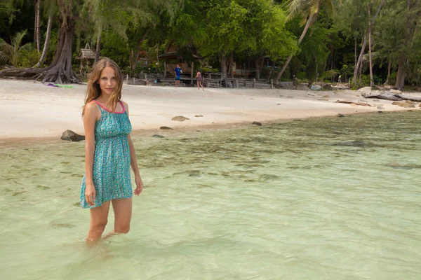 Woman standing knee-deep in water — Stock Photo, Image