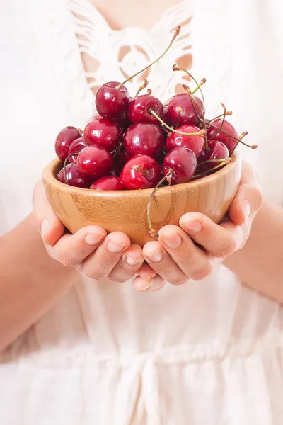 Bowl of cherries in womens hands — Stock Photo, Image