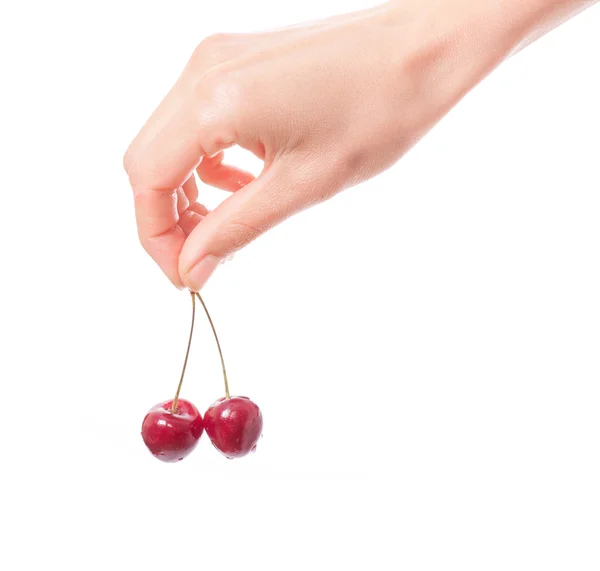 Hand holding  two cherries on white background — Stock Photo, Image