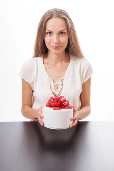 Jeune femme et boîte cadeau ronde sur la table — Photo