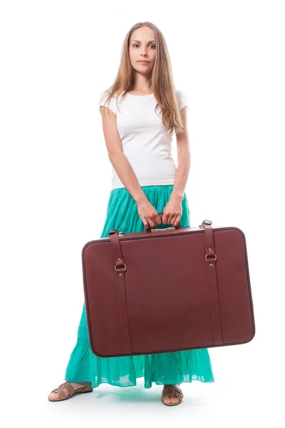 Woman lifts a heavy suitcase, isolated on white — Stock Photo, Image