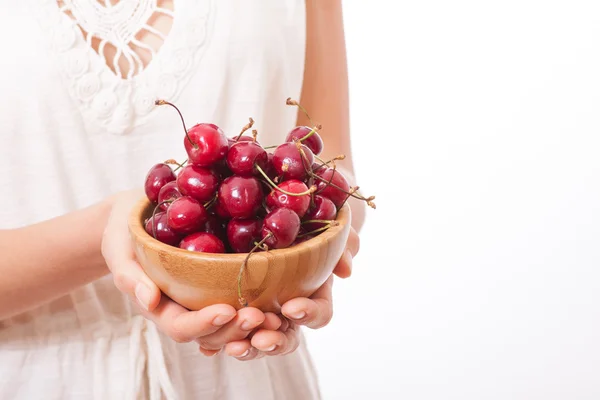 Bowl of cherries in womens hands — Stock Photo, Image