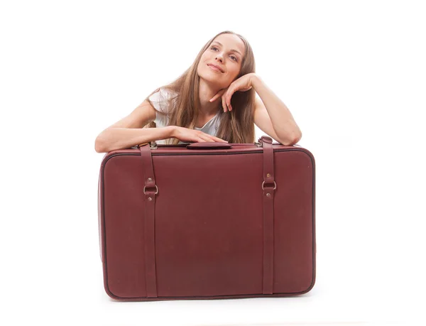 Girl sitting near a suitcase — Stock Photo, Image