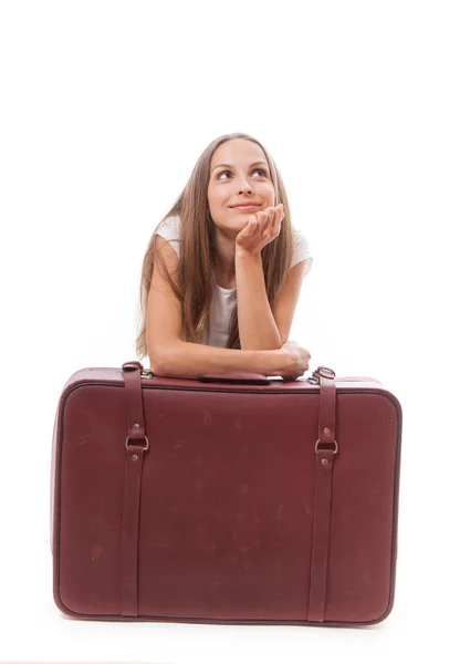 Девушка сидит рядом с чемоданом — стоковое фото