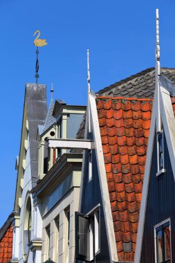 Colorful and historic house facades in De Rijp, Alkmaar, North Holland, Netherlands. De Rijp is known for its rijksmonuments, which include some of the oldest wooden houses of North Holland