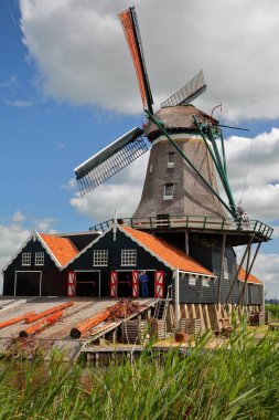 IJLST, NETHERLANDS - July 16, 2022: Windmill De Rat (The Rat) in IJlst, Friesland, a smock mill (dated from 1711) listed as Rijksmonument and still used nowadays as a sawmill