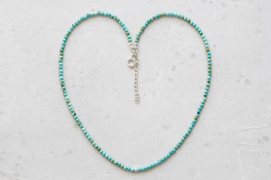 Turquoise necklace. A short necklace made of natural turquoise stones. Handmade jewelry made from natural stones. Modern jewelry. Natural turquoise choker heart. clipart