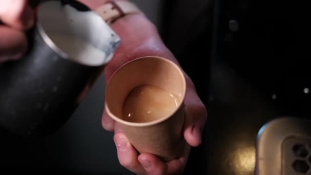 Искусство латте от баристы. наливать молоко в кофе. Темная кофейня. замедленное движение — стоковое видео