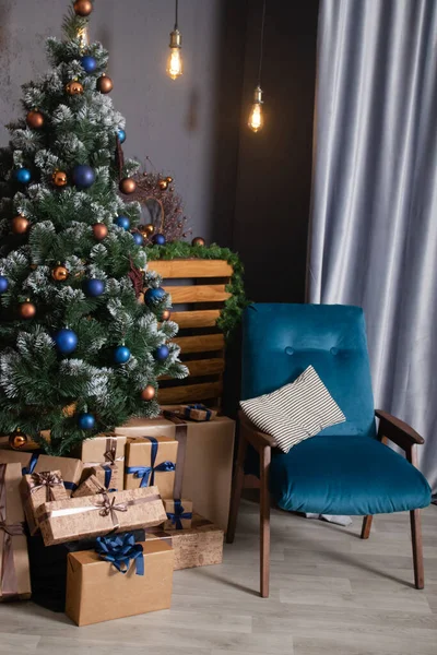 Stylový podkrovní interiér s krásným vánočním stromečkem. tmavě modré a hnědé a zlaté barvy. nové roky atmosféra dekorace. — Stock fotografie