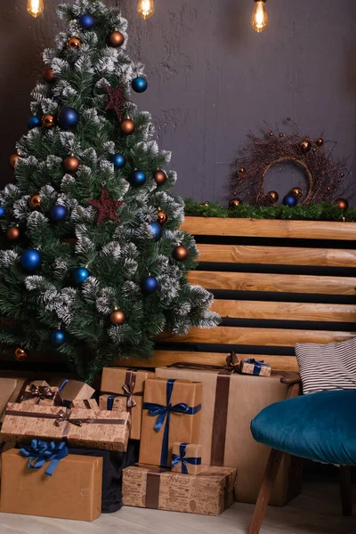 Stijlvol loft kamer interieur met mooie kerstboom. donkerblauw en bruin en gouden kleuren. nieuwjaar sfeer decoratie. — Stockfoto