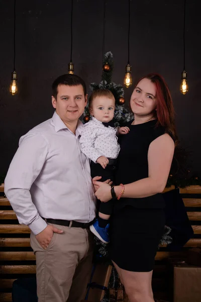 Happy european family. wife husband and a son. mother father and little boy. near christmas tree. happy new year and merry christmas. family time, happy holidays. young parents. formal clothing — Stock Fotó