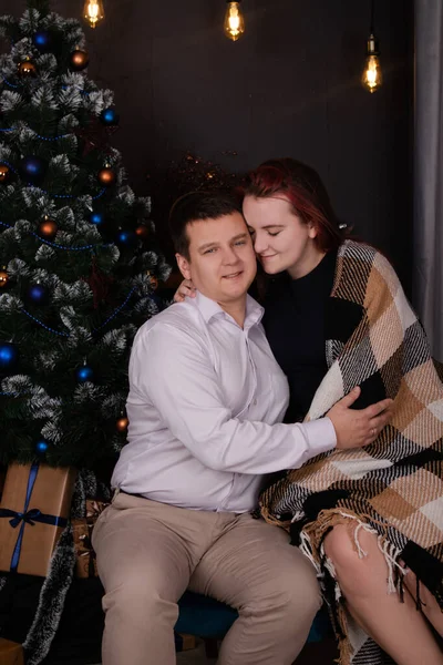 Happy couple near christmas tree and decorations. family on new years eve. wife and husband in love. successful marriage — Stock Fotó