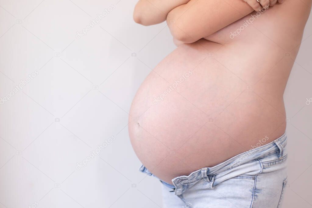 cute woman pregnant belly close up. happy pregnancy time. young mother to be with cute big tummy.