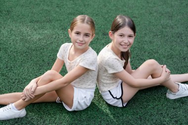 sisterhood. two sisters or friends spending time outdoors on sunny summer day. bff, sibling, girlfriend. millennial teen.