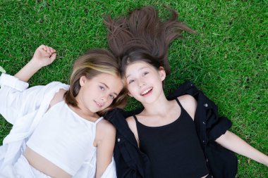 happy and lucky to have a sister. two girls outdoors in black and white clothes. good and bad. obedient and harmful. fraternal twins teen sisters